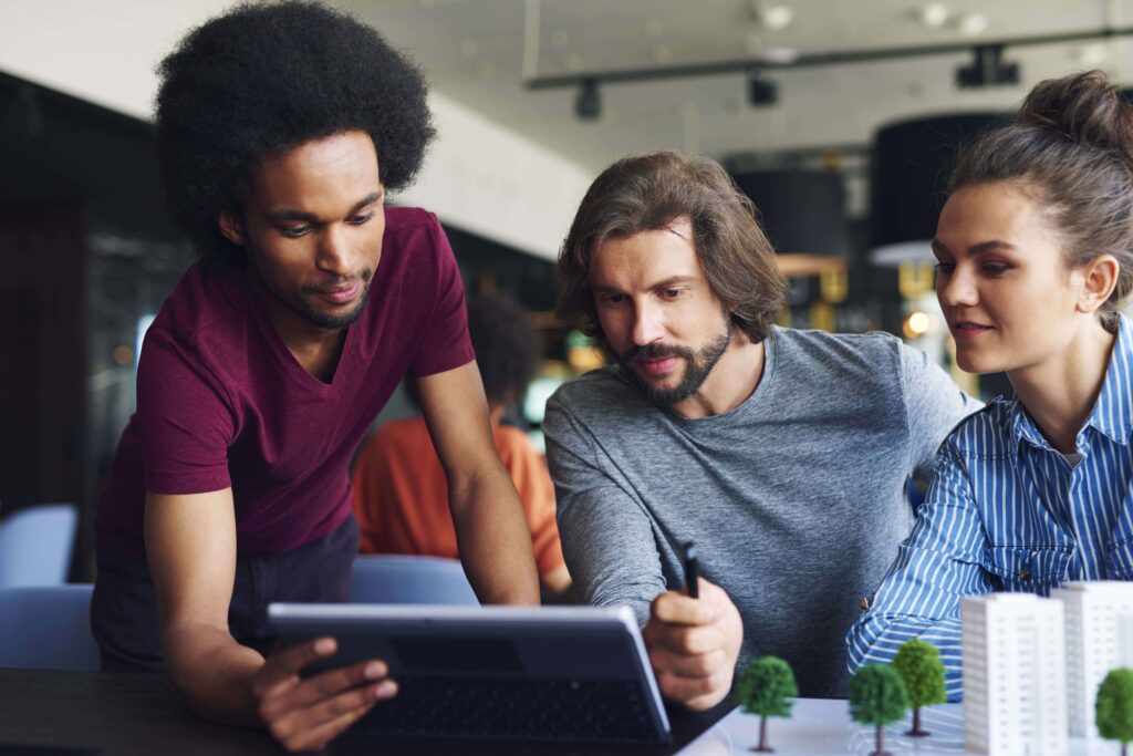 Colegas adultos jóvenes trabajando con tecnología